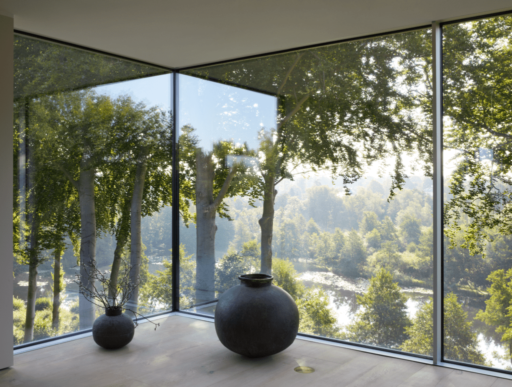 Beautiful living room with view through Sky-frame windows of garden